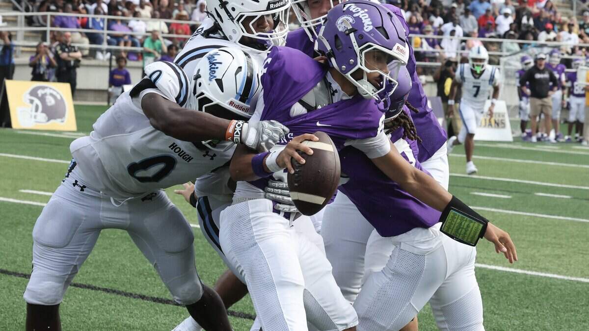 Hough High School defensive back Michael Griffin Jr. (0) tackles Northwestern High School quarterback Xavier Means in the end zone for a safety on Saturday, Aug. 22, 2026, at District Three Stadium in Rock Hill, South Carolina.