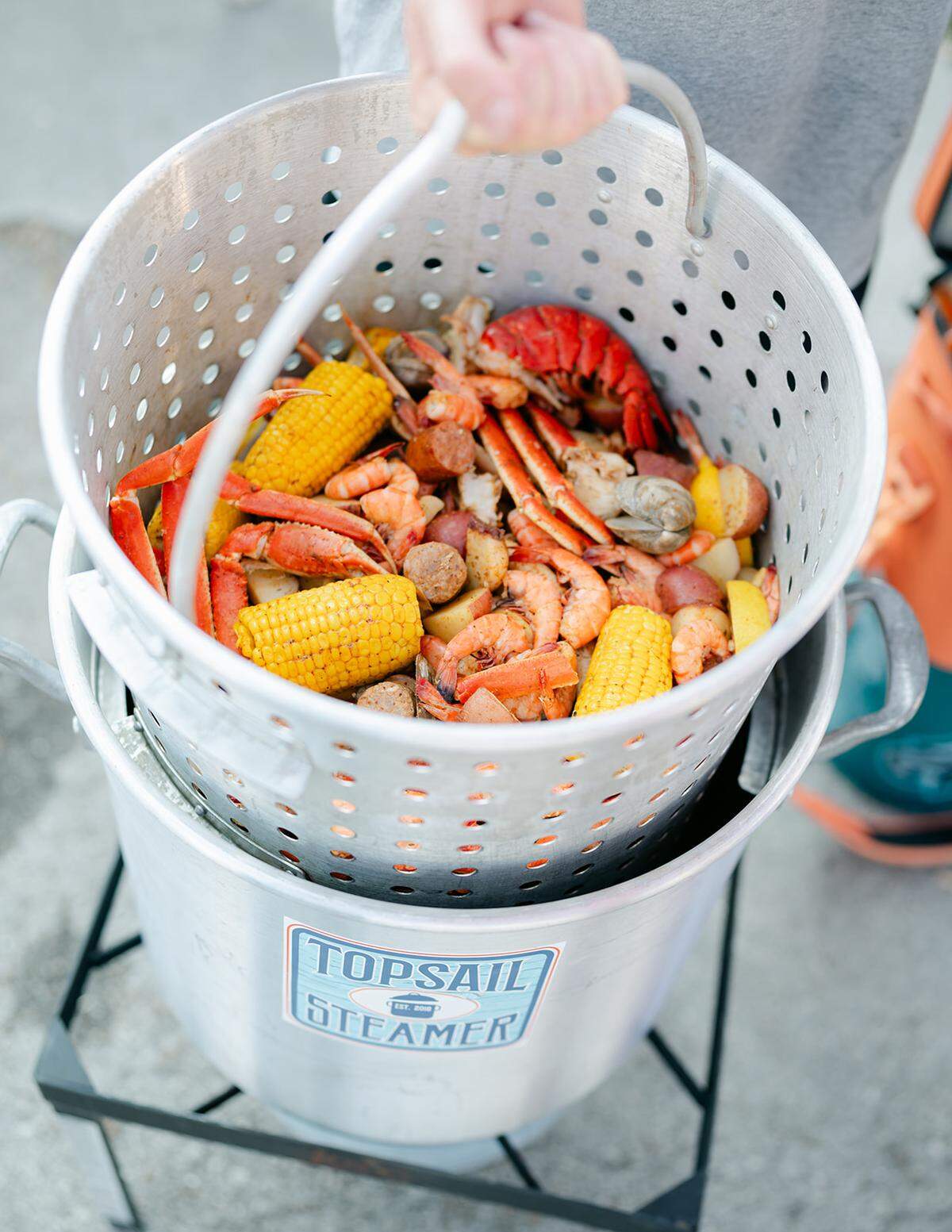 Topsail Steamer’s Bay Buckets come with fresh seafood and meat, corn, potatoes and its signature seasoning.