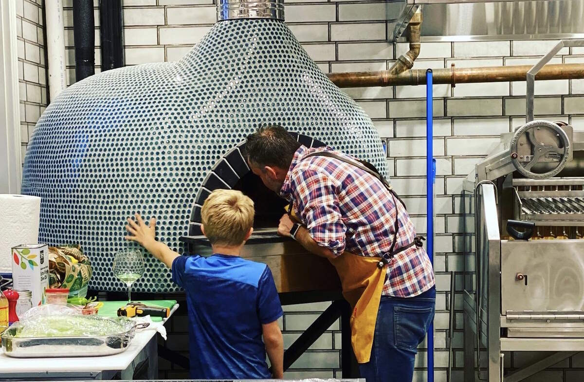 The Tonidandel family cooks in the Mugnaini fire oven at Supperland.
