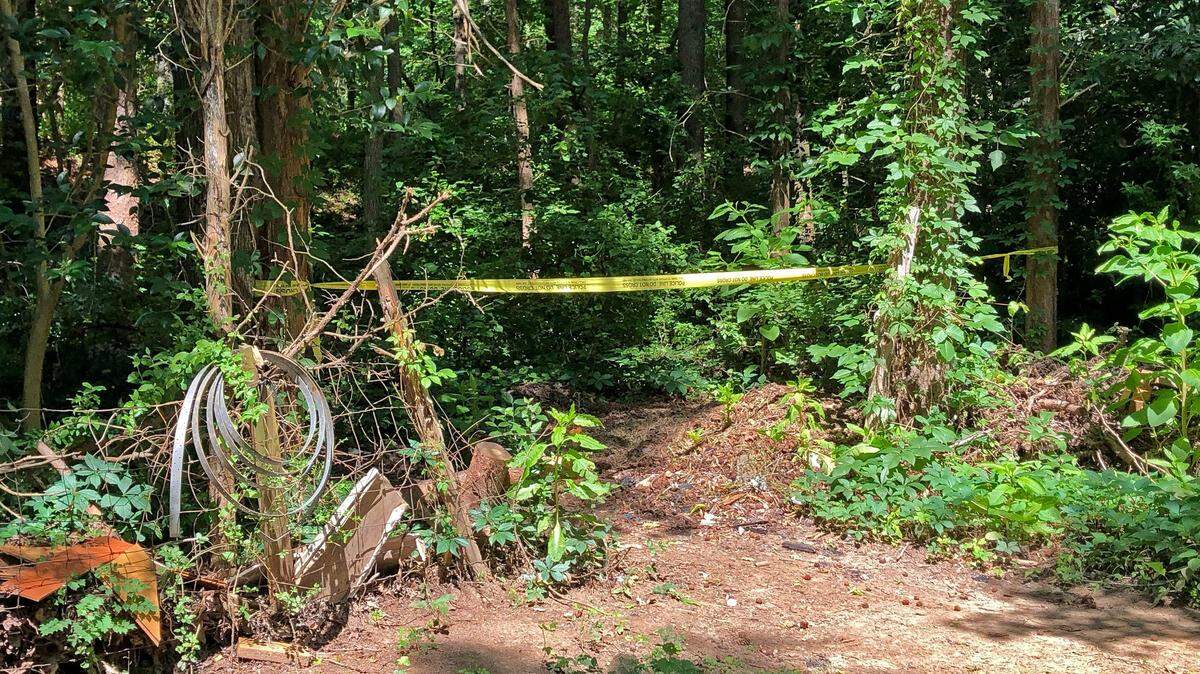 Police tape blocks the entrance to a dirt path behind mobile homes in the 200 block of Ann Elizabeth Drive, days after 14-year old Jonathan Miller was shot and killed. Two teenagers have been jailed for the killing.
