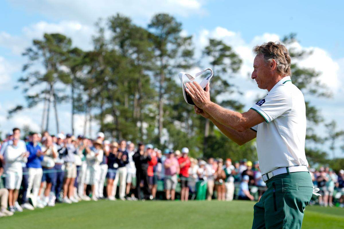 Bernhard Langer waves to patrons as he walks off no. 18 during the second round of the Masters Tournament at Augusta National Golf Club.