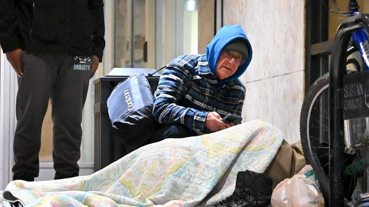 Point-in-Time Count volunteer Joe Hamby speaks with a person who is homeless along Church Street in uptown Charlotte, NC on Jan. 26, 2023. Each year, volunteers try to get an accurate count of how many people in Charlotte are homeless, live in shelters or tents or cars, or are otherwise unhoused.