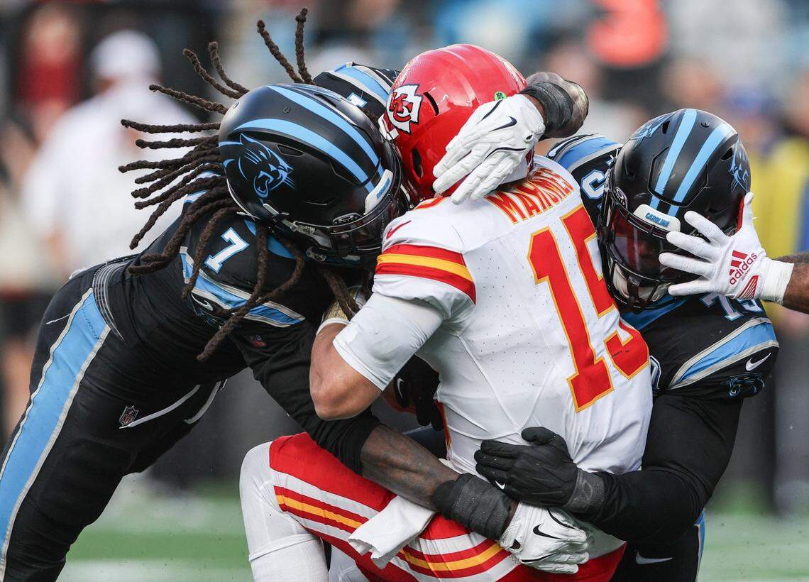 Former Panthers outside linebacker Jadeveon Clowney, left, and defensive lineman DeShawn Williams, sack Chiefs quarterback Patrick Mahomes during a 2024 game at Bank of America Stadium.  