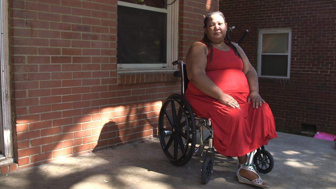 Tanya Lee sits on her front porch.