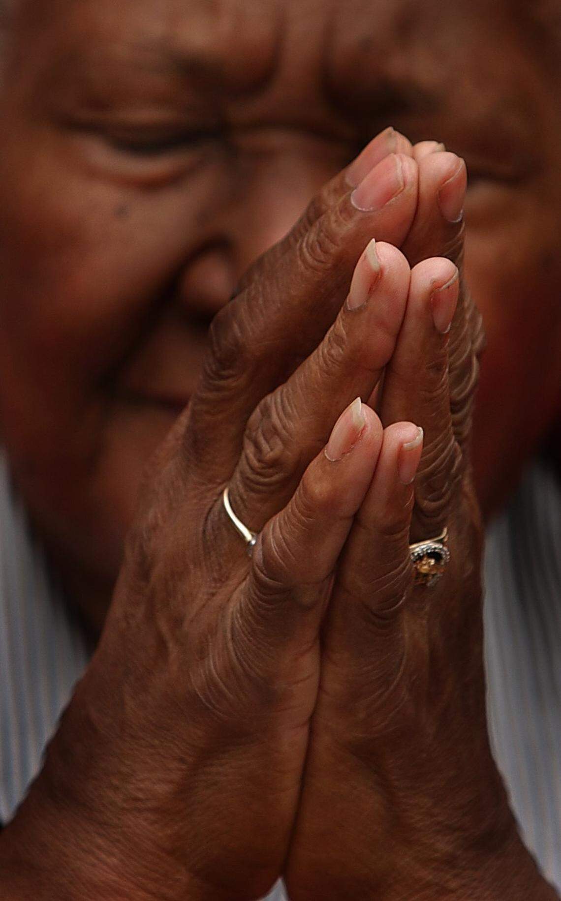 Sarah Stevenson presses her hands together as she prays during the National Day of Prayer in Charlotte. The group gathered outside the Government Center Plaza for prayer Thursday, May 02, 2002.