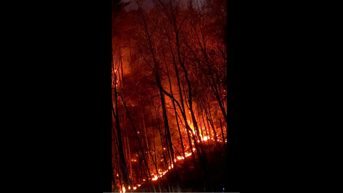 A motorcycle crash near ignited a wildfire that has spread to 100 acres inside Great Smoky Mountains National Park, according to Tennessee officials.