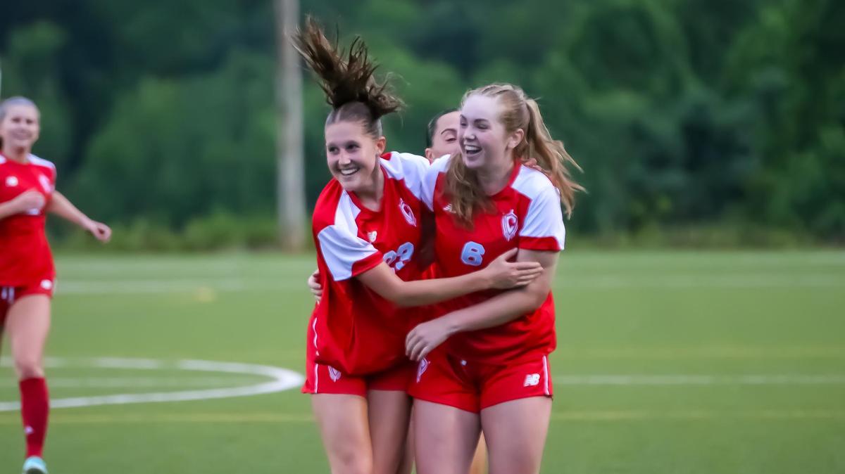 Midfield turns into a moment of triumph as Charlotte Catholic Jordyn Miller (left) and Tilley Hahn jump with joy after sealing the playoff win at the NCHSAA Girls Soccer playoffs on May 12, 2025 at the OrthoCarolina Sportsplex in Charlotte, North Carolina