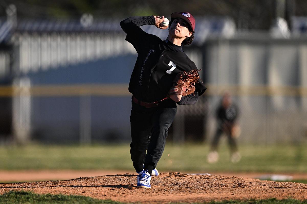 West Mecklenburg’s Emilio Garcia (7) throws a pitch during a varsity baseball game against West Charlotte, Tuesday, March 18, 2022, in Charlotte, N.C. (Charlotte Observer/Matt Kelley)