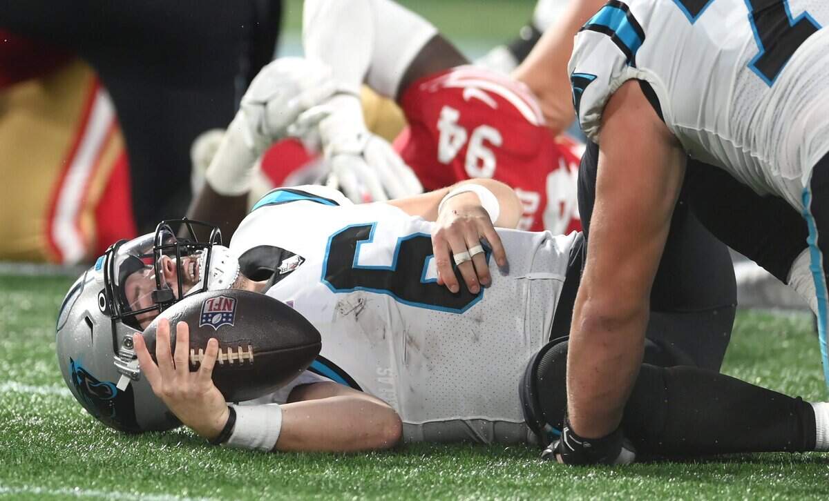 Carolina Panthers quarterback Baker Mayfield lies on the turf after being sacked by San Francisco 49ers defensive lineman Drake Jackson on Oct. 9, 2022. The 49ers defeated the Panthers 37-15, and head coach Matt Rhule was fired the next day.