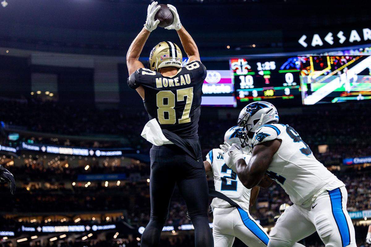 Sep 8, 2024; New Orleans, Louisiana, USA; New Orleans Saints tight end Foster Moreau (87) scores a touchdown against the Carolina Panthers during the first half at Caesars Superdome. Mandatory Credit: Stephen Lew-Imagn Images