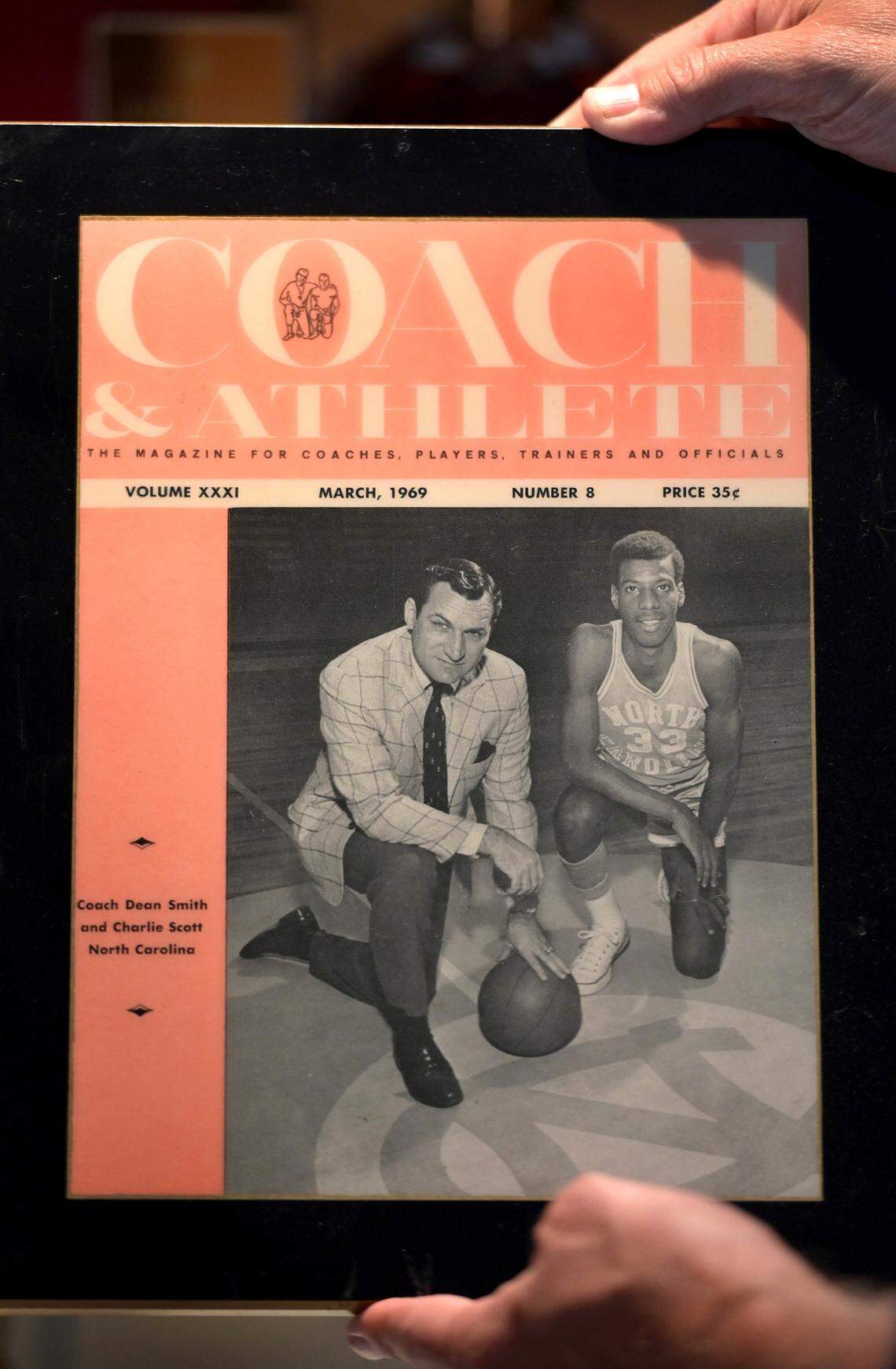 Legendary UNC head coach Dean Smith and Charlie Scott are pictured together on the March 1969 cover of Coach & Athlete. The magazine cover is among the mementos in the collection of former UNC Tar Heel, ABA and NBA basketball player Charlie Scott. Scott was a two-time All-American and three-time all Atlantic Coast Conference selection. He was inducted into the Naismith Memorial Basketball Hall of Fame in 2018.