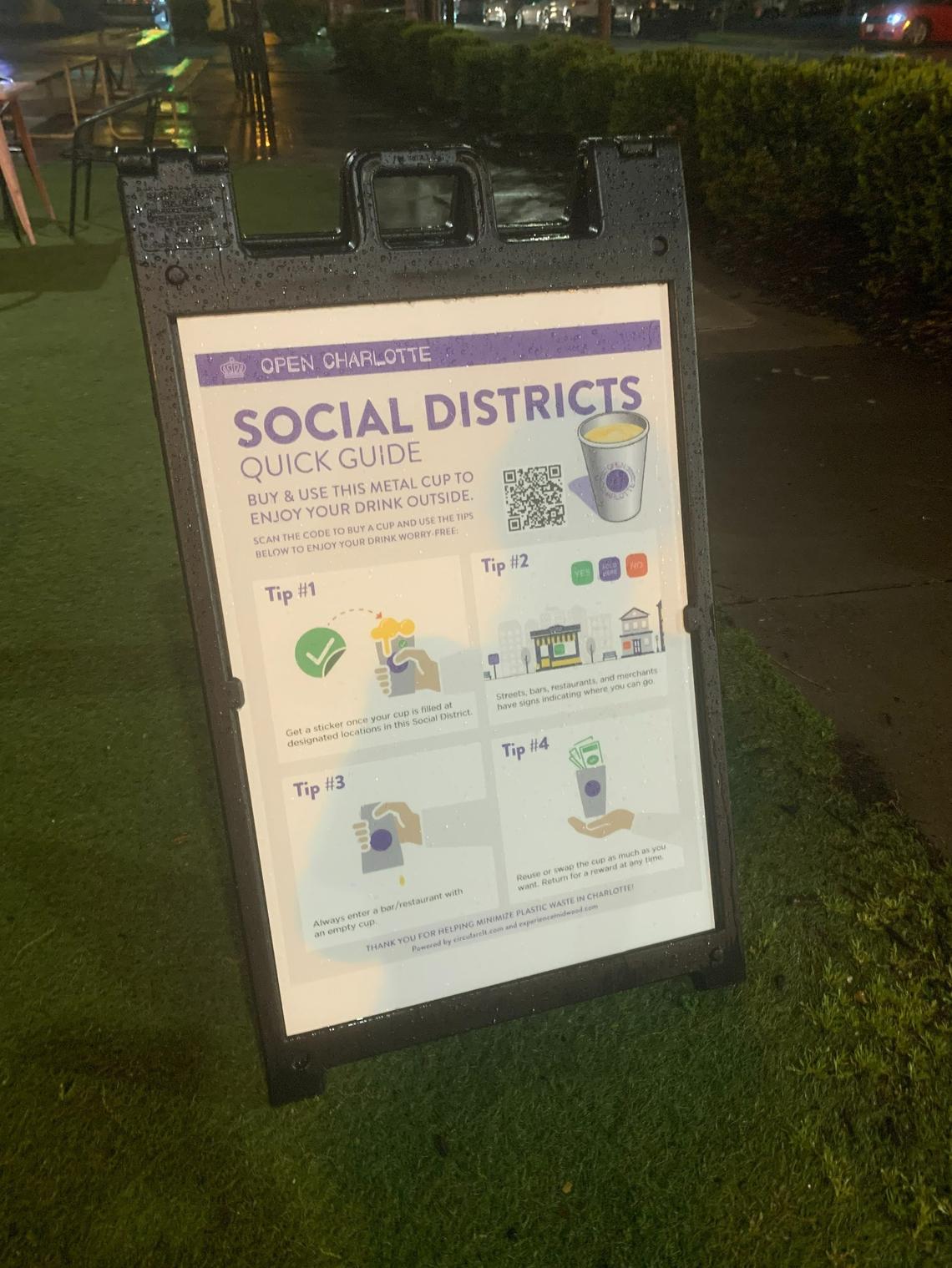 A guide to Charlotte’s first social district is displayed outside Pizza Peel on Central Avenue, one of the businesses participating in the district.