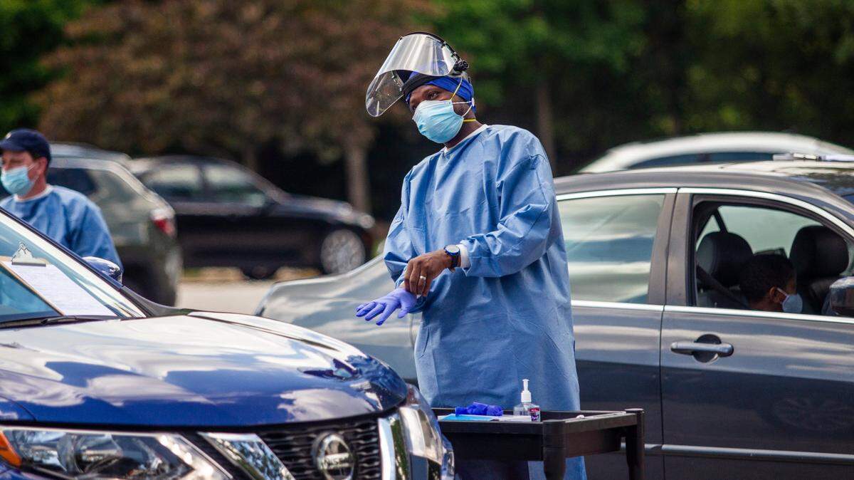 Gandhi Elamin conducts a coronavirus test at the Avery Street Recreation Center in Garner Friday, July 10, 2020. About 400 people received tests at the pop up testing site.