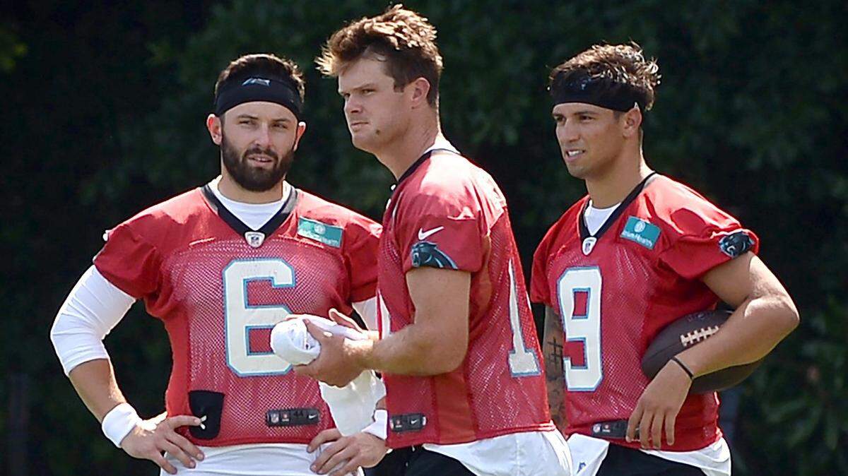 Carolina Panthers quarterbacks Baker Mayfield, left, Sam Darnold, center and Matt Corral, right, wait along a sideline to resume drills on Wednesday, July 27, 2022 at Wofford College in Spartanburg, SC.