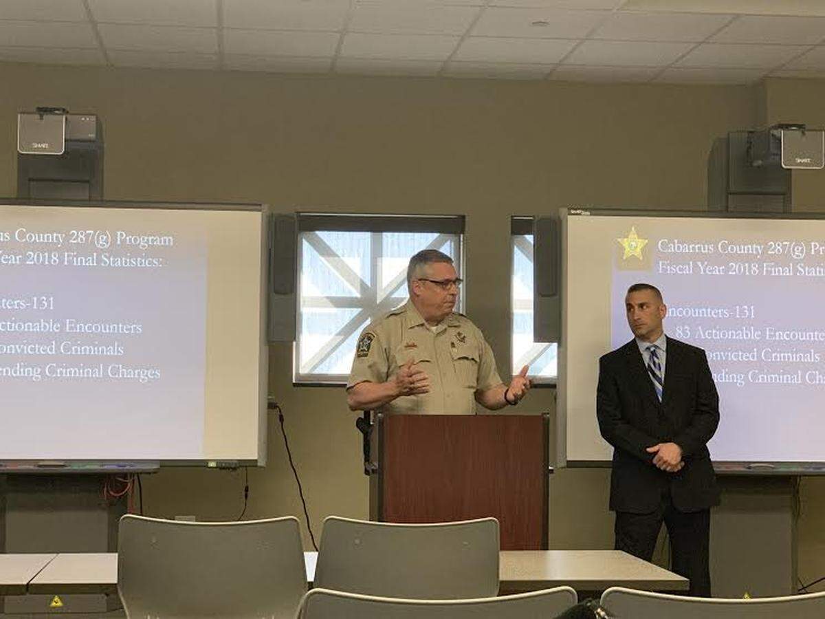 Cabarrus County Sheriff Van Shaw speaks about his office’s participation in the 287(g) program, which enables sheriff’s deputies to carry out federal immigration enforcement. Steve La Rocca, an Immigration and Customs Enforcement official who works with the county, looks on.