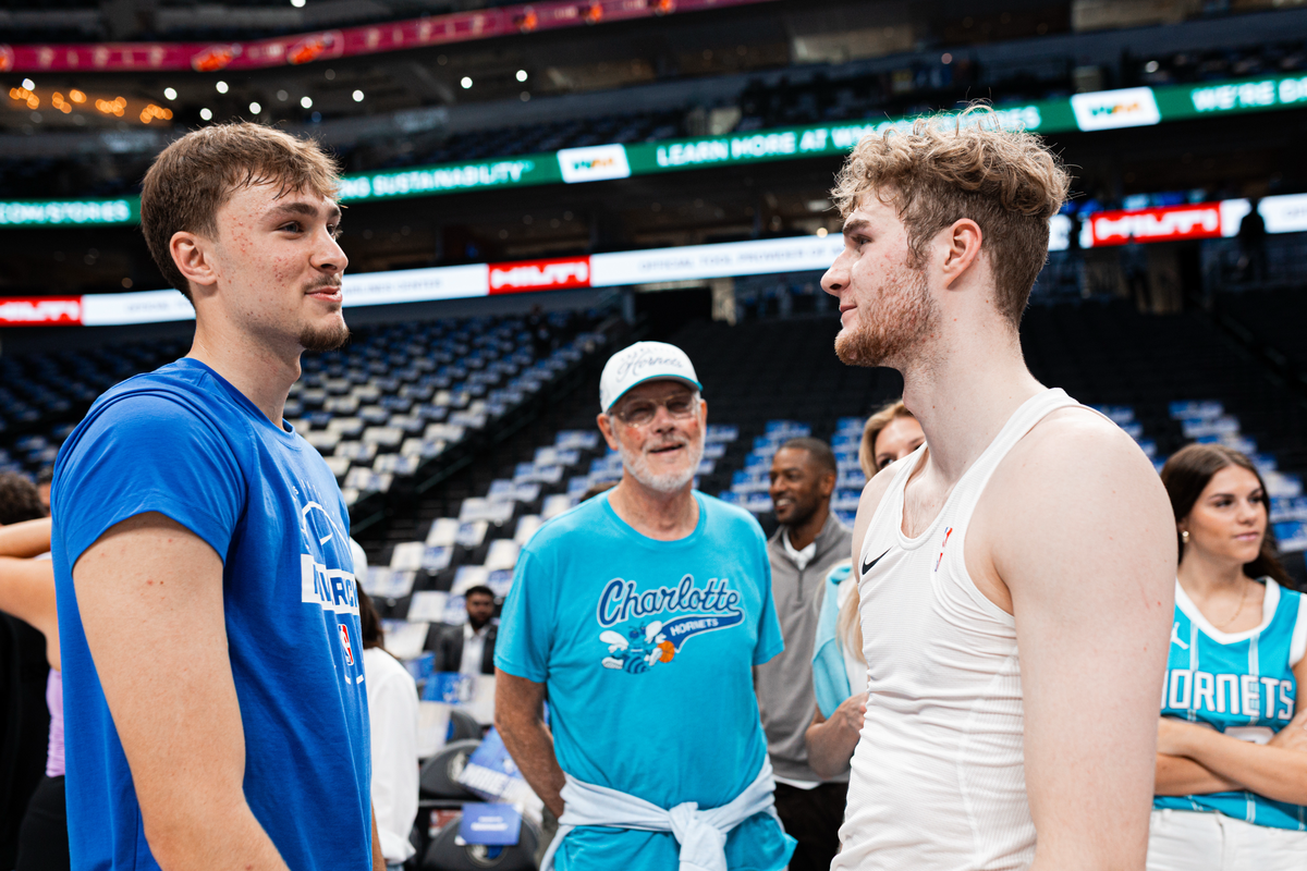 Charlotte Hornets forward Liam McNeeley (right) chats with Dallas Mavericks forward Cooper Flagg before Saturday’s preseason game at American Airlines Center.