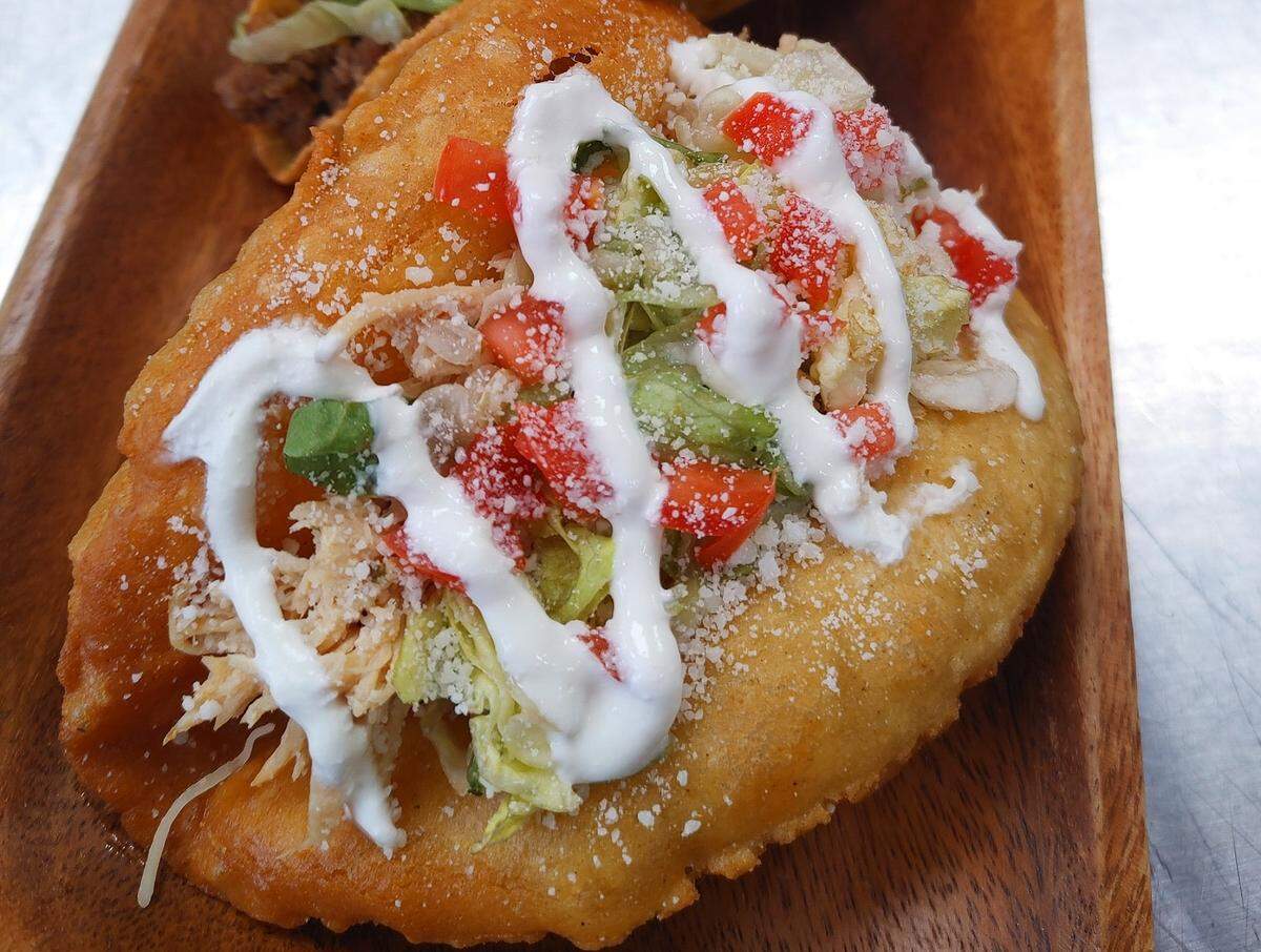 The 210 Puffy Taco comes with pulled chicken or ground beef. It’s stuffed in a fresh handmade, deep fried corn tortilla and topped with lettuce, tomato, cotija cheese and Mexican crema.