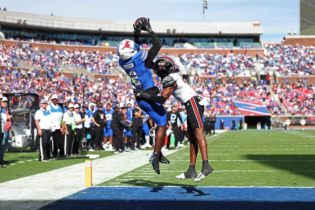 Southern Methodist wide receiver Jordan Hudson catches a pass for a touchdown in front of Louisville defensive back Jabari Mack during the first half at Gerald J. Ford Stadium on November 22, 2025 in Dallas, Texas. (Photo by Stacy Revere/Getty Images)