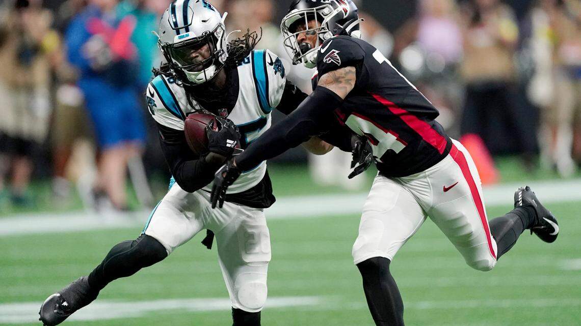 Carolina Panthers cornerback Donte Jackson, left, intercepts a pass intended for Atlanta Falcons wide receiver Damiere Byrd, right, during the first half of an NFL football game Sunday, Oct. 30, 2022, in Atlanta. (AP Photo/John Bazemore)