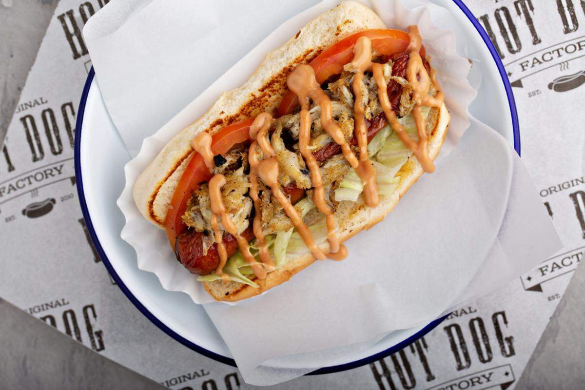 The Surf n Turf Dog at the Original Hot Dog Factory is topped with lump crab meat, lettuce, tomatoes and “Try Me” sauce.