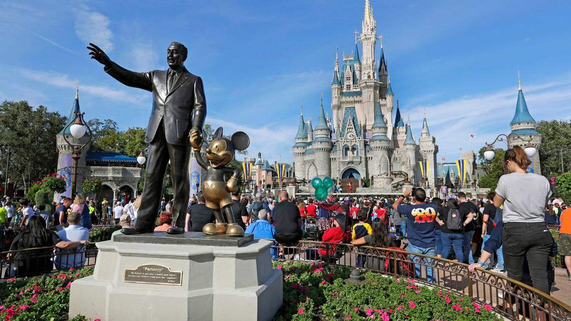 In this 2019 file photo, Disney World guests watch a show near a statue of Walt Disney and Micky Mouse at Walt Disney World in Florida. After a feud with Disney World, Republican Gov. Ron DeSantis signed legislation on April 23, 2022 stripping the theme park of a decades-old special agreement that allowed it to govern itself.