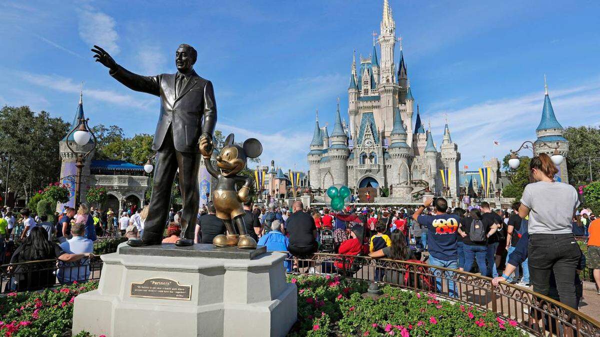 In this 2019 file photo, Disney World guests watch a show near a statue of Walt Disney and Micky Mouse at Walt Disney World in Florida. After a feud with Disney World, Republican Gov. Ron DeSantis signed legislation on April 23, 2022 stripping the theme park of a decades-old special agreement that allowed it to govern itself.