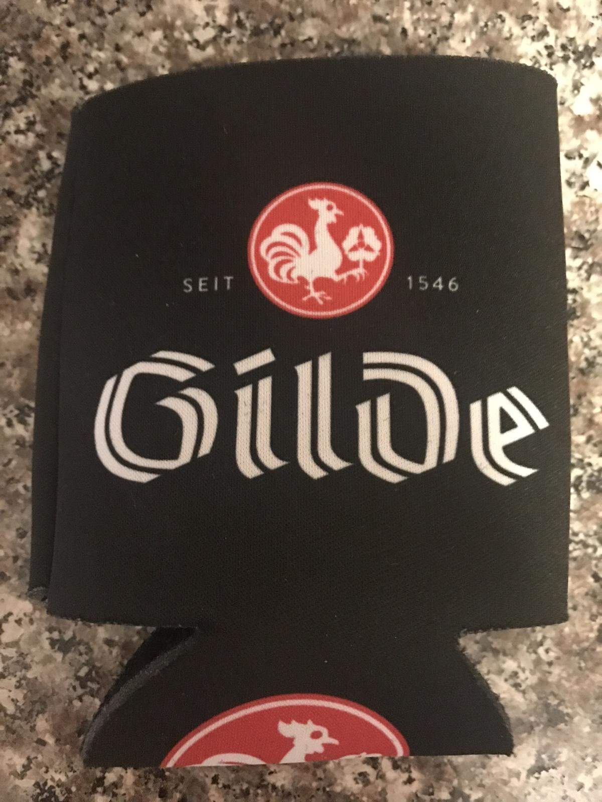 A Gilde koozie, a foam holder meant to keep beer cold