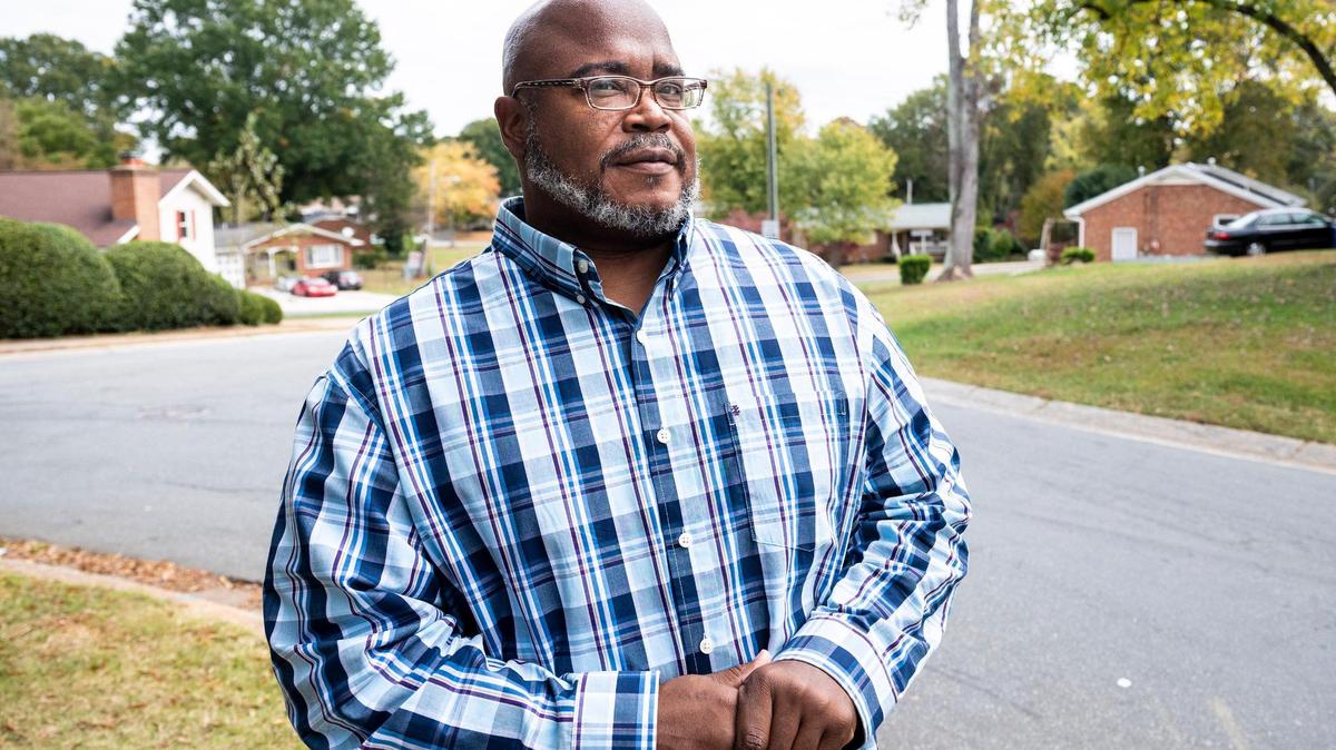 Charles Robinson, Vice President of the Home Owner’s Association in Hidden Valley, poses for a portrait at the entrance for the neighborhood on Wednesday.