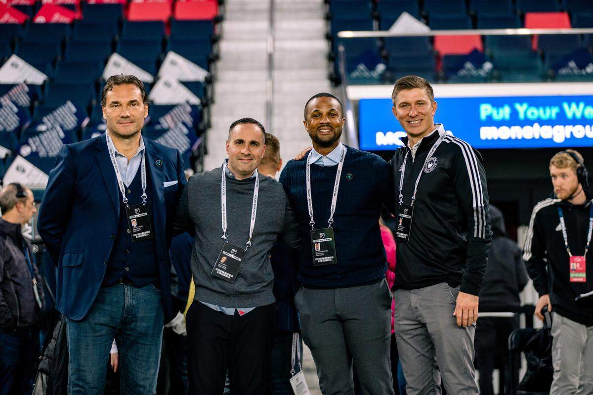 Key Charlotte FC executives pose for a photo before a Charlotte FC contest against St. Louis in March 2023. From left to right: Zoran Krneta (Charlotte FC sporting director), Joe LaBue (Charlotte FC president), Darrius Barnes (Crown Legacy FC presidnet), Bobby Belair (Charlotte FC technical director).