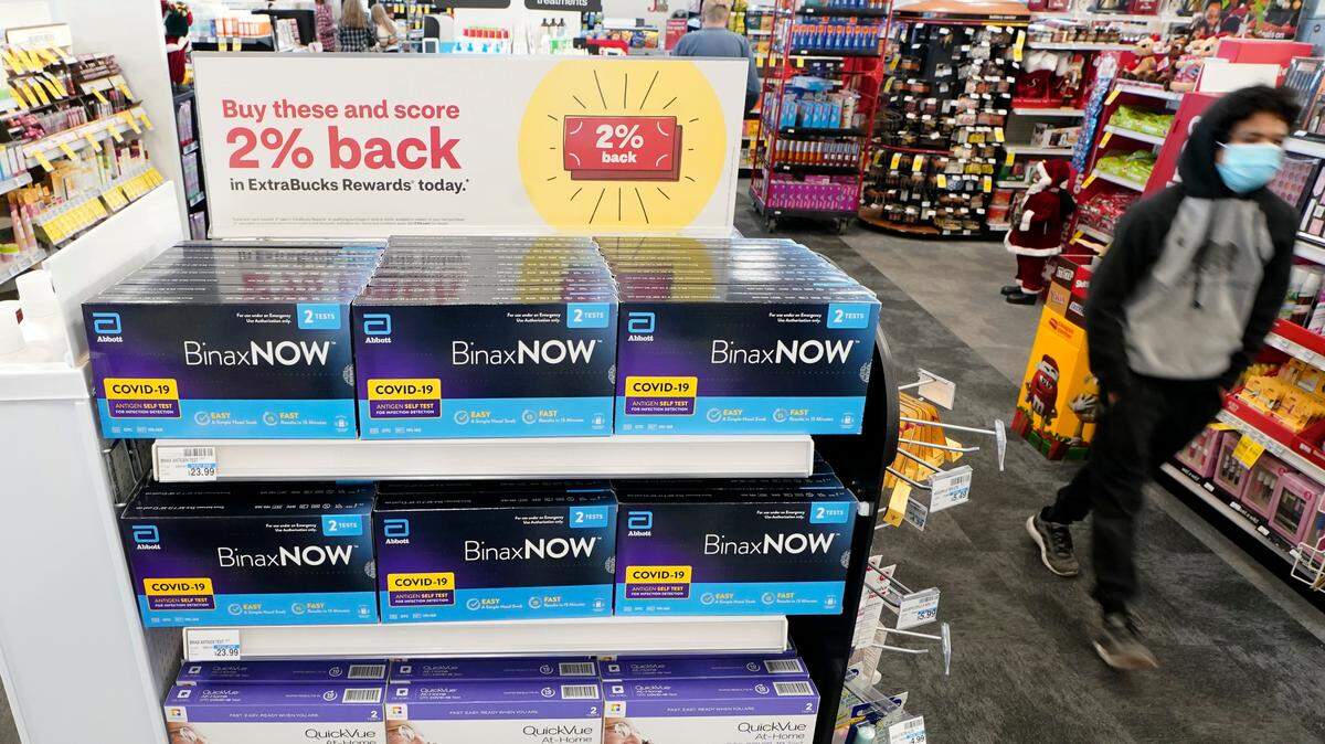 Boxes of BinaxNOW and QuickVue home COVID-19 tests are shown for sale Monday, Nov. 15, 2021, at a CVS store in Lakewood, Washington, south of Seattle.