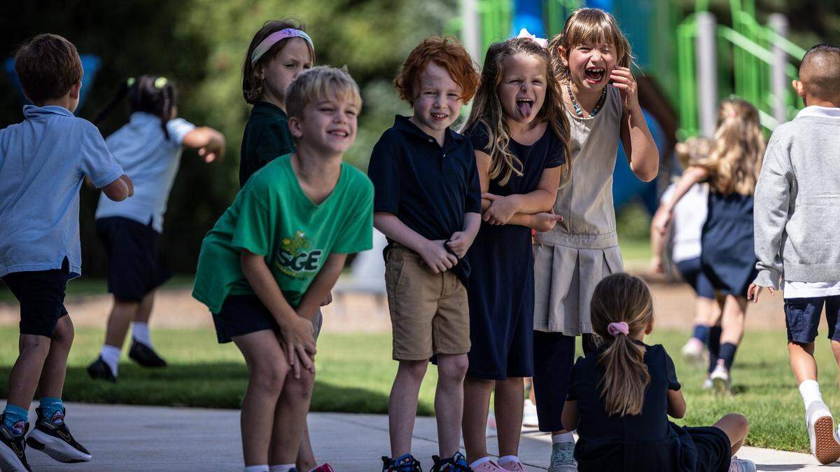 Charlotte-Mecklenburg Schools is deciding on a calendar for the 2025-26 school year and wants public input. In this 2022 file photo, a group of students laugh together at recess during the first day of school at Shamrock Gardens Elementary School in Charlotte.
