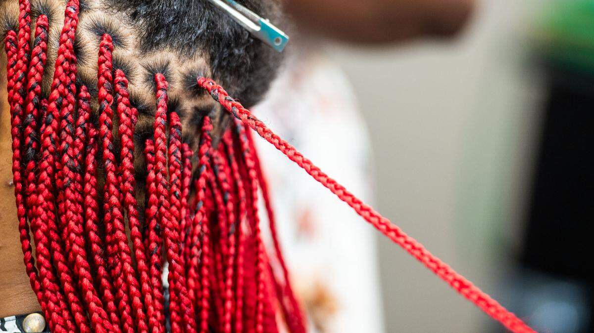 A woman getting colored knotless box braids at Top African Hair Braiding in Charlotte on August 7, 2024.