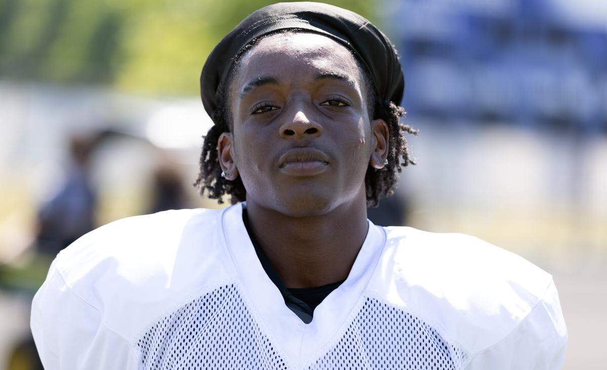 Jarron “Ricky” Lorick pauses between drills during Garinger High School’s spring football workouts. Lorick, entering his second year under the current leadership, noted a significant shift in team culture, citing increased discipline and offensive production as key turning points for the program.