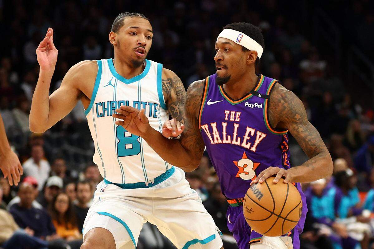 Phoenix Suns guard Bradley Beal (3) dribbles the ball past Charlotte Hornets guard Nick Smith Jr. (8) during the first half at Footprint Center.