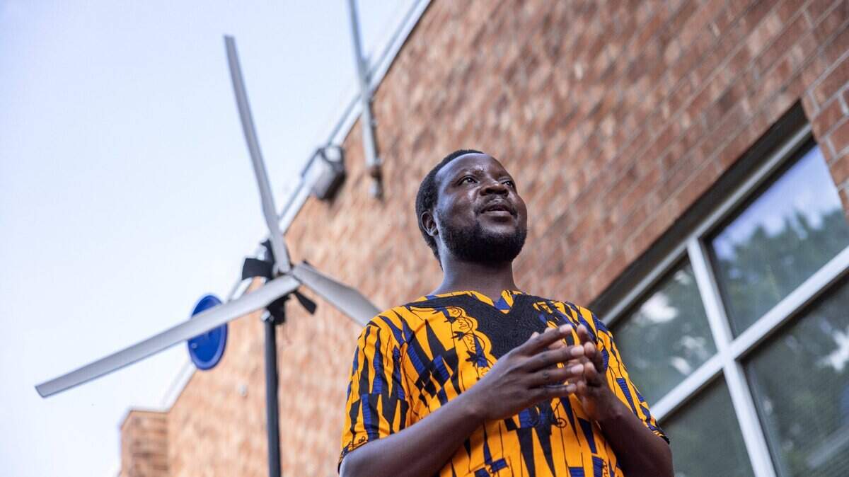 William Kamkwamba speaks during a dedication ceremony for a windmill he built and dedicated to Randolph Middle School in Charlotte Monday. The windmill resembles the one featured in his bestselling book, “The Boy Who Harnessed the Wind.”