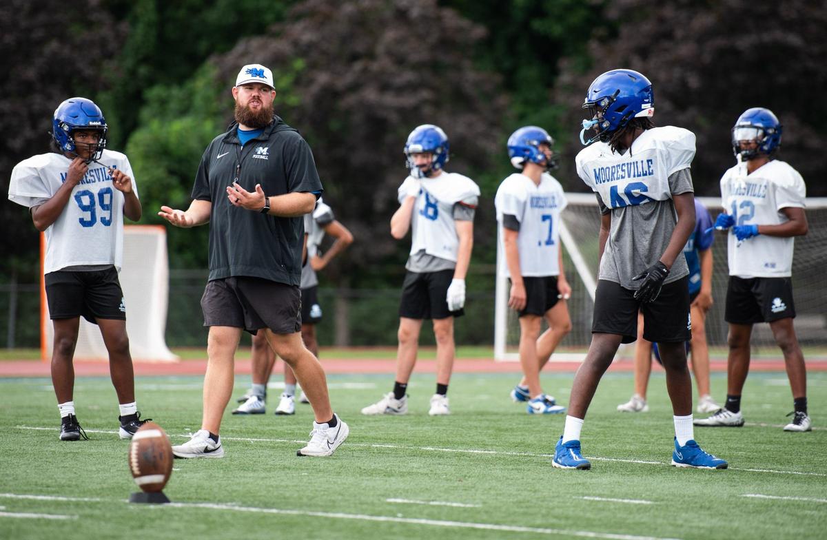 Coach Zach Mayo talking to his team during a morning practice at Coach Joe Popp Stadium on July 25, 2024.