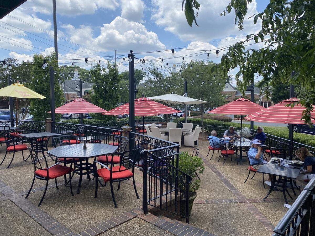 Harper’s Restaurant has a two level patio with bright red cushions