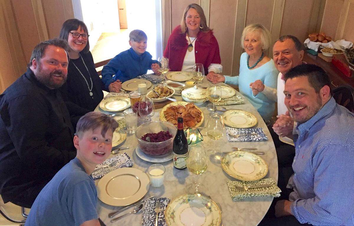 Casey Hickey with her family gathered around the table for Thanksgiving.