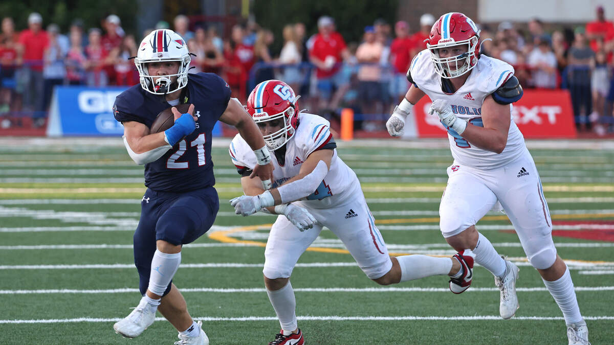 Providence Day running back Ian Cline, left, breaks to the outside on a run during first half action against Charlotte Catholic on Friday, September 1, 2023 at Providence Day School.