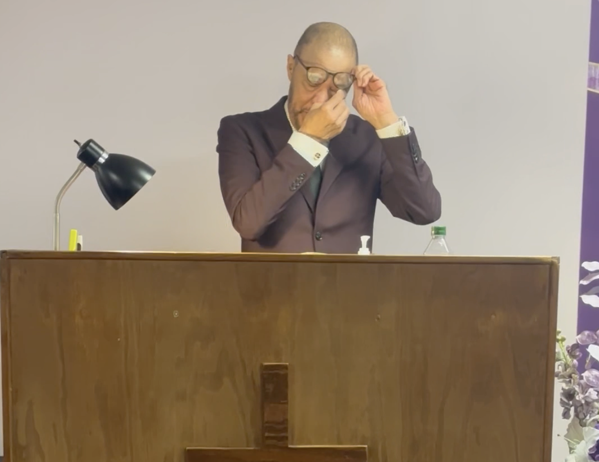 Pastor Kelvis Reid wipes away tears last September, when he returned for his first sermon since undergoing a dual heart and kidney transplant earlier that year.