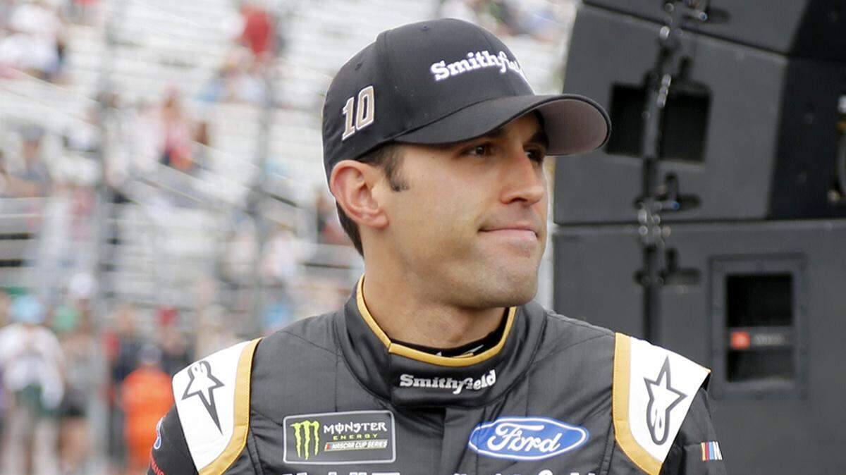 Aric Almirola smiles as he walks to his race car after being introduced before the start of the NASCAR Cup Series auto race Sunday, July 22, 2018, at New Hampshire Motor Speedway in Loudon, N.H. (AP Photo/Mary Schwalm)