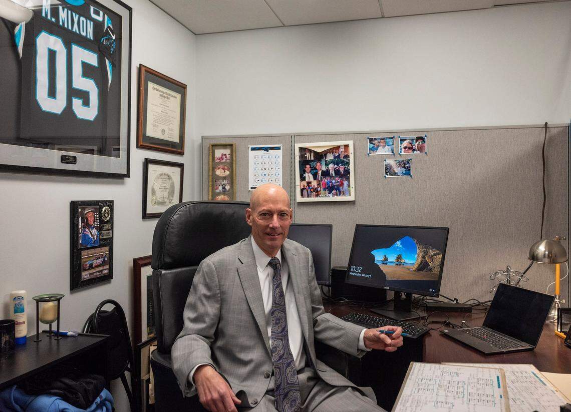 Mick Mixon poses for a portrait at his desk at Bank of America Stadium on Wednesday, January 5, 2022 in Charlotte, NC. After seventeen years as the voice of the Panthers Radio Network, this Sunday will mark Mixons final game as he retires after the end of this season.