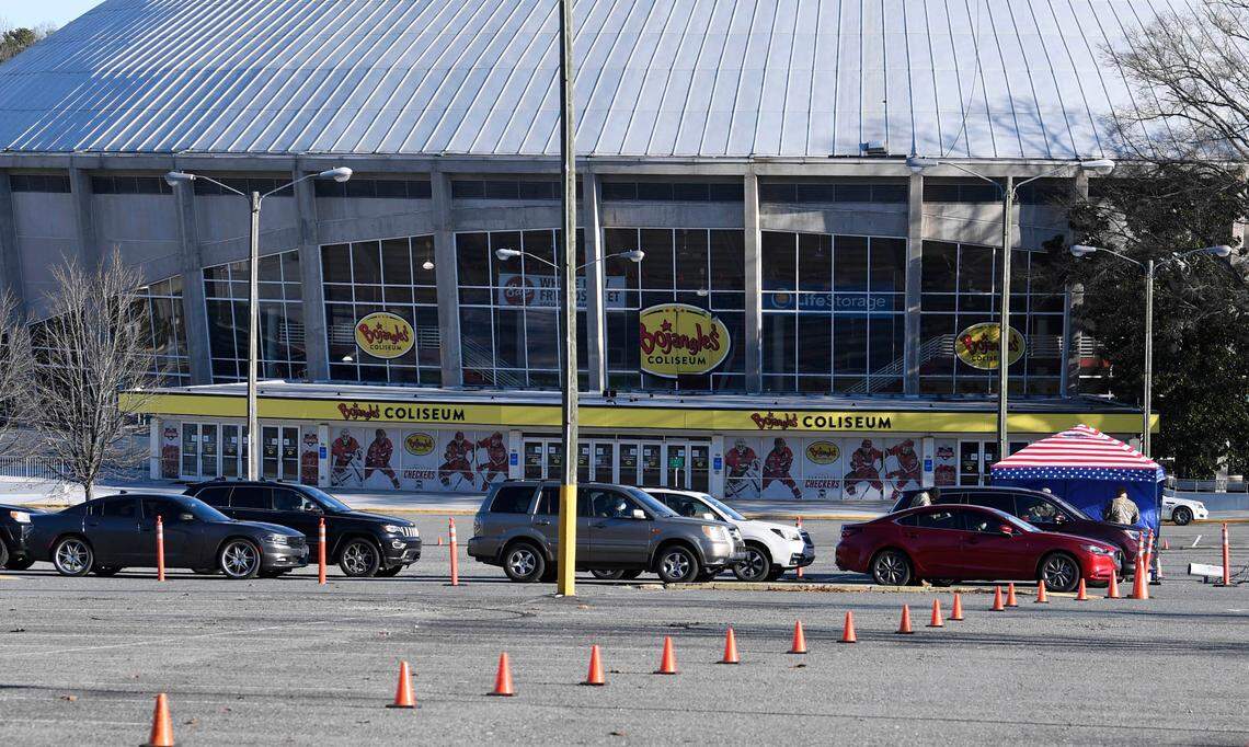 N.C. National Guard members direct people checking in at BojanglesÕ Coliseum for COVID vaccination appointments on Wednesday, January 6, 2021.