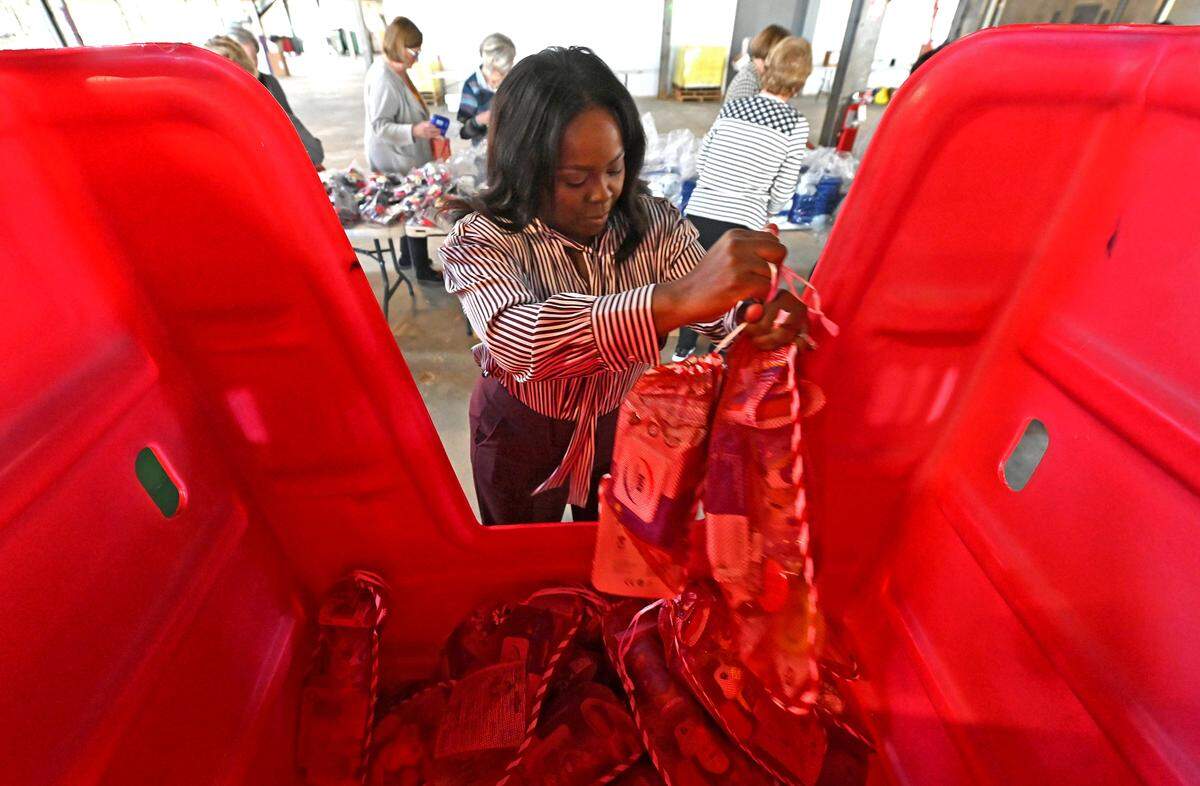 Volunteers with the Salvation Army Women’s Auxiliary of Greater Charlotte gather Christmas stocking items in this 2022 file photo.
