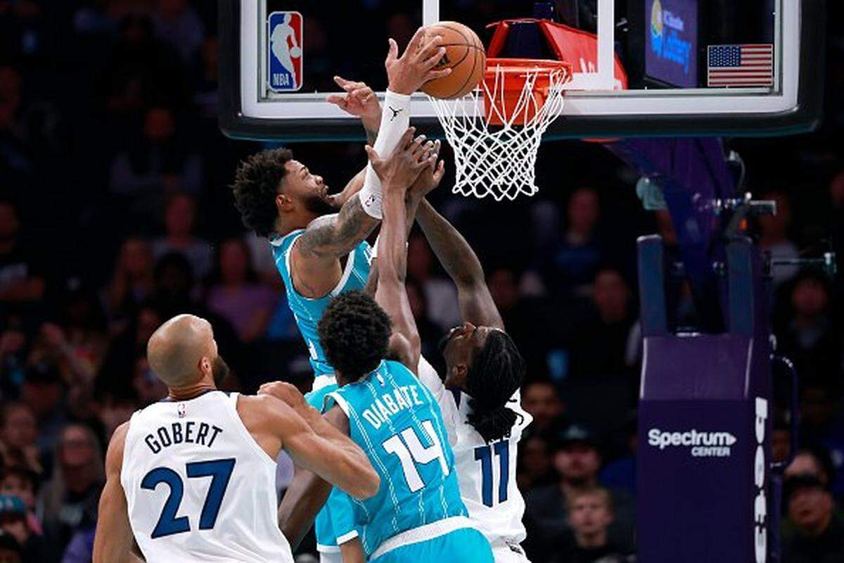 Miles Bridges of the Charlotte Hornets battles Naz Reid of the Minnesota Timberwolves for a rebound during the first half of the NBA game at Spectrum Center on Nov. 1, 2025 in Charlotte, North Carolina.