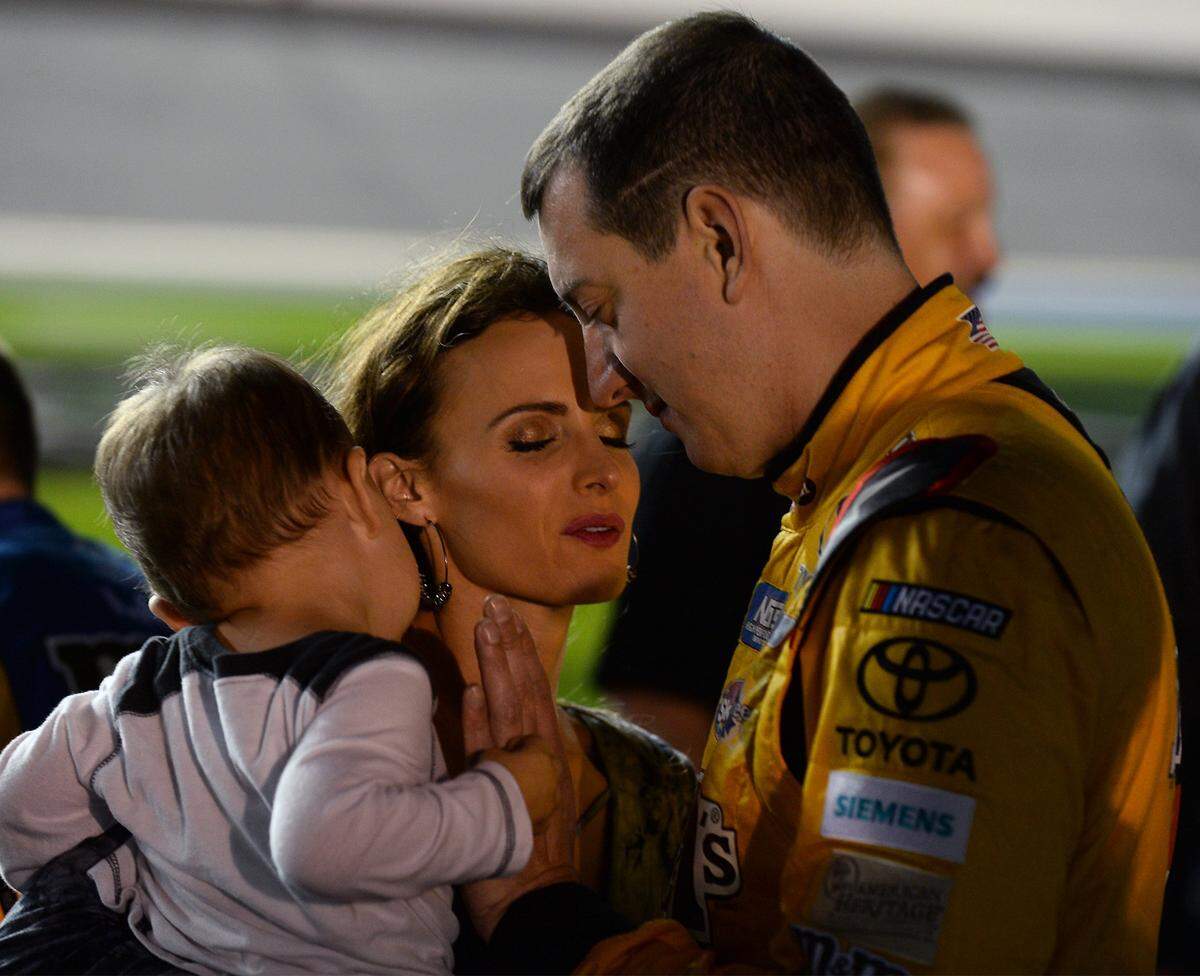 NASCAR driver Kyle Busch (right) prays with his wife Samantha and son Brexton before a race at Daytona in 2017.