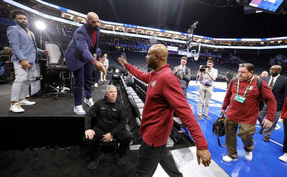 Florida State head coach Leonard Hamilton gets a hand shake from Carlos Boozer as he walks off the court for the last time after Syracuse’s 66-62 victory over Florida State in the first round 2025 ACC Men’s Basketball Tournament at the Spectrum Center in Charlotte, N.C.,Tuesday, March 11, 2025.