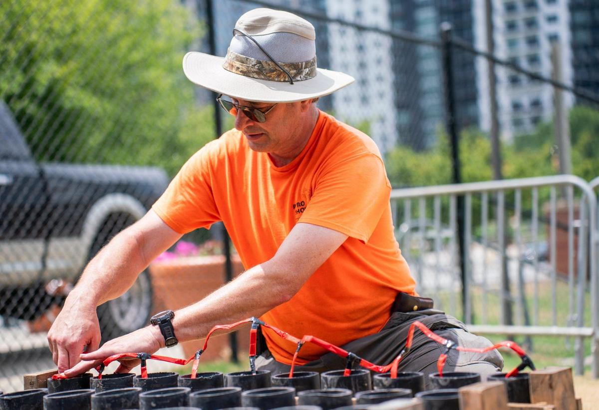 Russell Ellis preparing a few shells for the Fourth of July show at Truist Field.