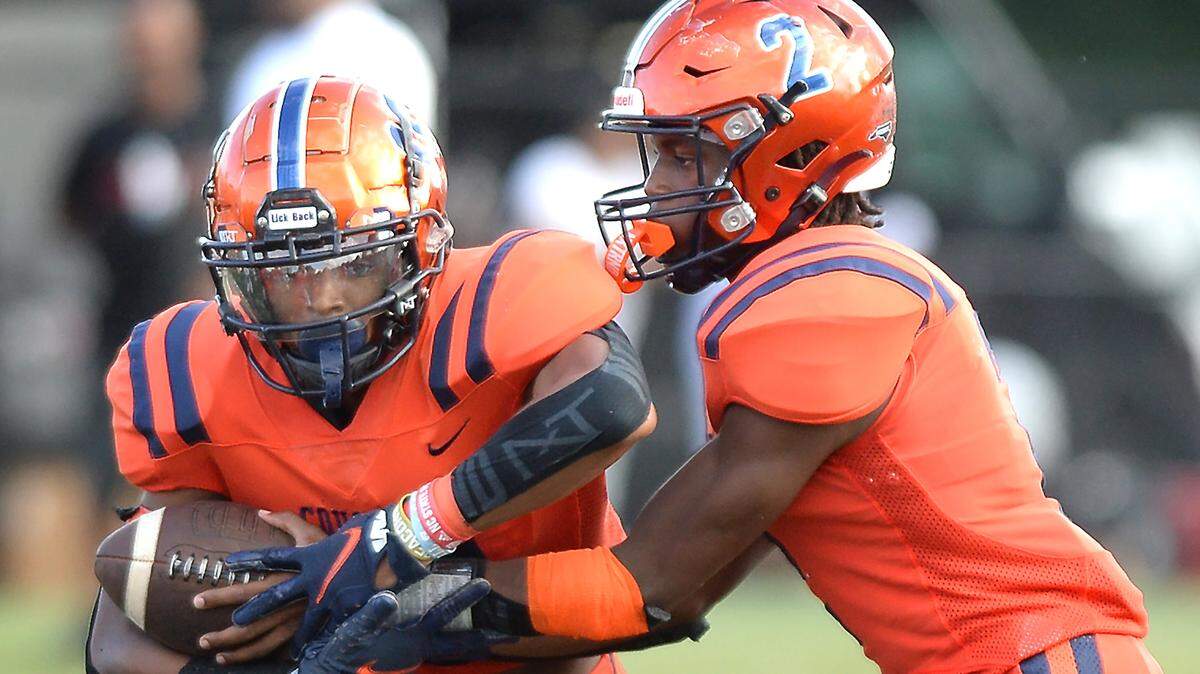 Chambers running back Braylon Vinson, left, takes the handoff from quarterback Anshon Camp, right, during action against Cardinal Gibbons on Saturday, August 20, 2022 at District 3 Stadium in Rock Hill, SC.
