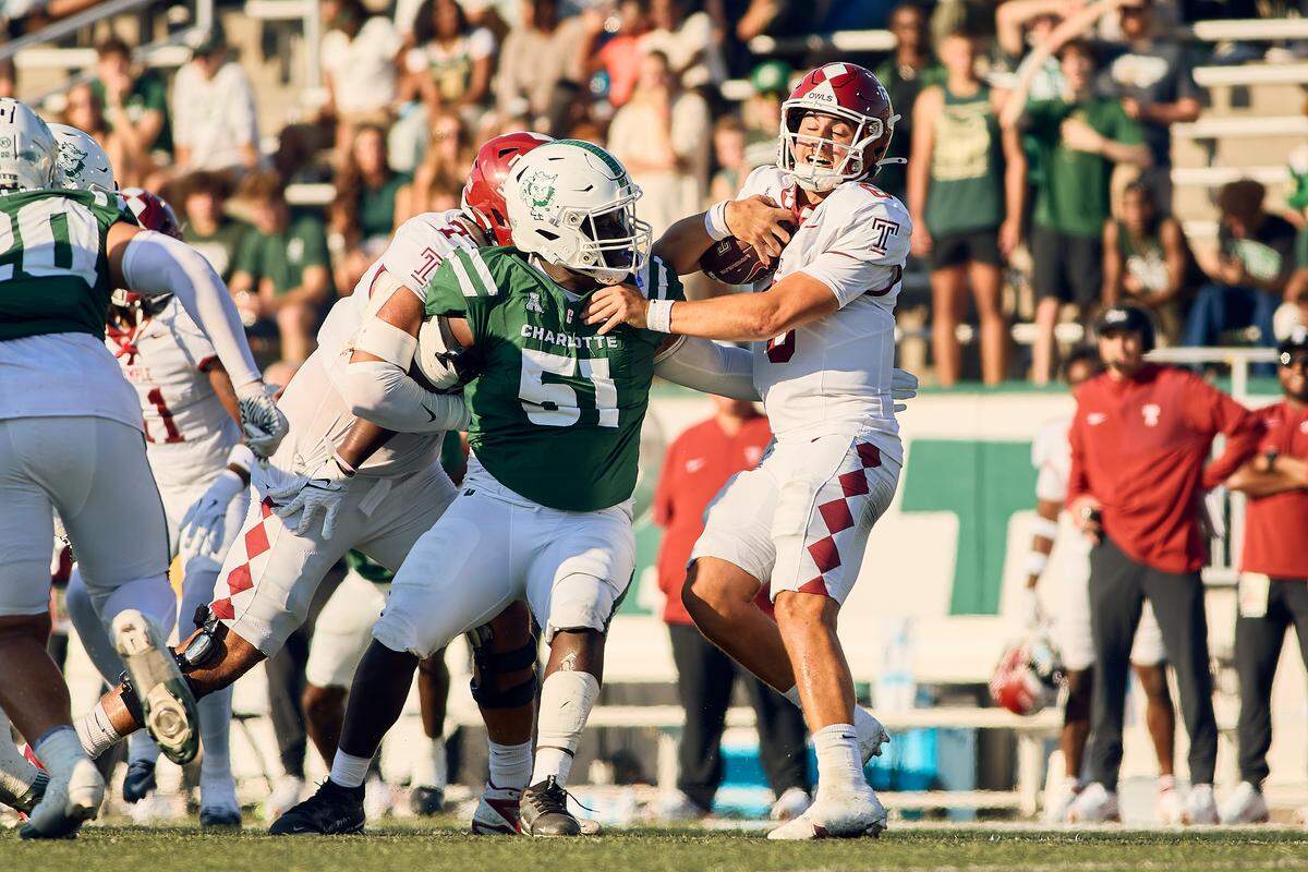 Charlotte 49ers DT Jamarrion Solomon (51) takes down  Temple quarterback Evan Simon for the first sack of the evening at Jerry Richardson Stadium for Homecoming.